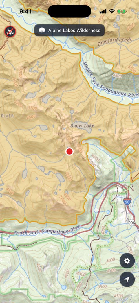 The map at Melakwa Lake with the Alpine Lakes Wilderness named across the top and a prohibition marker in the corner.